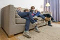 Bored children gaming on a couch Royalty Free Stock Photo