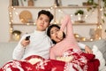 Bored Chinese Couple Watching TV Yawning Celebrating Christmas At Home Royalty Free Stock Photo