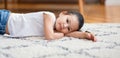 Bored Chinese Little Girl Lying On Floor At Home, Panorama