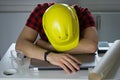 Bored construction Worker is lying on a laptop