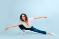 Bored contemporary dancer in a lunge with arms spread apart in a straight line Royalty Free Stock Photo