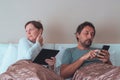 Bored couple, husband and wife in bedroom