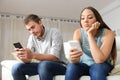 Bored couple online with smart phones Royalty Free Stock Photo