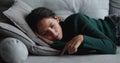 Bored disinterested young woman lying on sofa.