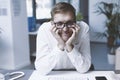 Bored employee sitting at desk and doing nothing