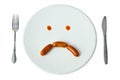 Bored face sausage on white dish Royalty Free Stock Photo