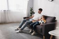 Father and son watching tv while Royalty Free Stock Photo