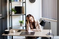 Tired business woman sitting at her working place. Overwork, working overtime and stress at work concept Royalty Free Stock Photo