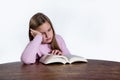 Bored girl with book on white background Royalty Free Stock Photo