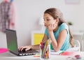 Bored girl with laptop and notebook at home Royalty Free Stock Photo