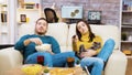 Bored girl sitting on the couch with the cat in her lap Royalty Free Stock Photo