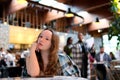 Bored Girl Waiting for her Date in a Coffee Shop. Stood up woman having a bad time alone in the restaurant Royalty Free Stock Photo