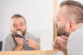 Bored guy brushing his teeth in bathroom Royalty Free Stock Photo