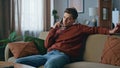 Bored guy calling cellphone relaxing at couch. Serious man talking smartphone Royalty Free Stock Photo