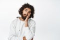 Bored hispanic man roll eyes, lay head on hand annoyed, unamused and uninterested, standing over white background