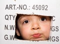 Bored kid peeking out from a cardboard box Royalty Free Stock Photo