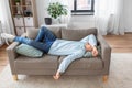 bored or lazy young man lying on sofa at home Royalty Free Stock Photo