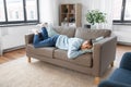 bored or lazy young man lying on sofa at home