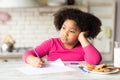 Bored Little African American Girl Drawing At Table In Kitchen Royalty Free Stock Photo