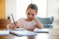 Bored little girl child unmotivated doing homework Royalty Free Stock Photo