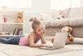 Bored little girl doing homework on laptop Royalty Free Stock Photo