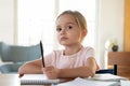 Bored little girl look in distance distracted from studying Royalty Free Stock Photo