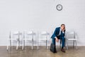 Bored man with briefcase sitting on chair Royalty Free Stock Photo