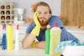 bored man holding cleaning product