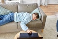 bored man with laptop lying on sofa at home Royalty Free Stock Photo