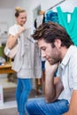 Bored man sitting in front of his girlfriend Royalty Free Stock Photo