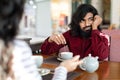 Bored man sitting at table in front of his date Royalty Free Stock Photo