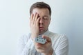 Bored man watching tv and zapping closing face with hand Royalty Free Stock Photo
