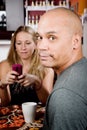 Bored man with woman on cell phone Royalty Free Stock Photo