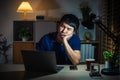 bored man working with laptop at night Royalty Free Stock Photo