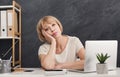 Bored mature businesswoman at office desk Royalty Free Stock Photo