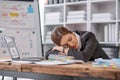 Bored at office work funny sleepy woman worker resting on hand sleeping at workplace, unmotivated lazy woman feeling Royalty Free Stock Photo