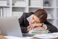 Bored at office work funny sleepy woman worker resting on hand sleeping at workplace, unmotivated lazy woman feeling Royalty Free Stock Photo