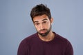 Bored, portrait and annoyed man in studio tired and moody against a grey background space. Fatigue, face and man with