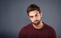 Bored, portrait and annoyed man in studio unhappy and moody against a grey background space. Sad face of depression and