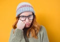 Bored portrait of beautiful girl looking at camera, isolated on yellow background