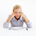 Bored, portrait and woman with a plate in a studio with upset, frustrated and grumpy face. Angry, hungry and young