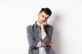 Bored and reluctant stylish guy look at camera without emotions, attend boring meeting, standing on white background Royalty Free Stock Photo