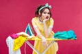 Bored sad young woman ironing clothes Royalty Free Stock Photo