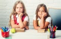 Bored school kids at lesson. Back to school and home schooling. Friendship of small sisters in classroom at knowledge Royalty Free Stock Photo