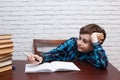 Bored schoolboy ponders over the task solution. Elementary schoo Royalty Free Stock Photo