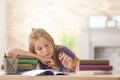 Bored schoolgirl doing homework indoors Royalty Free Stock Photo