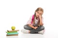 Bored schoolgirl with books with apple Royalty Free Stock Photo