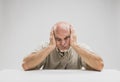 Bored senior man with a glum despondent expression Royalty Free Stock Photo