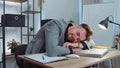 Bored sleepy business man worker working on laptop computer, yawning, falling asleep at office Royalty Free Stock Photo