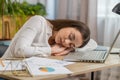 Bored sleepy young business woman worker working on laptop computer, falling asleep at home office Royalty Free Stock Photo